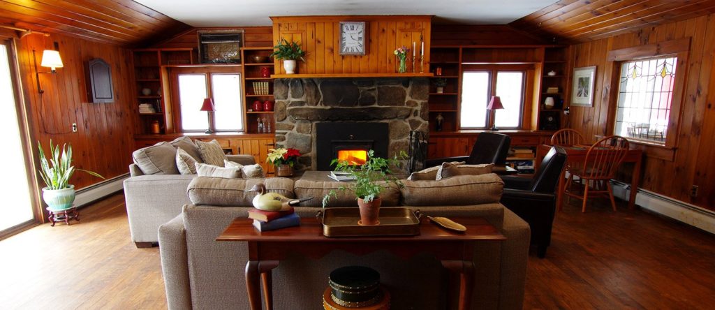 The Wilmington Inn interior shot. Fireplace with wooden walls.